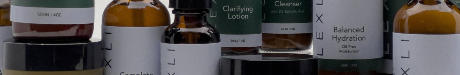 close up of several skin care bottles with blue and green labels